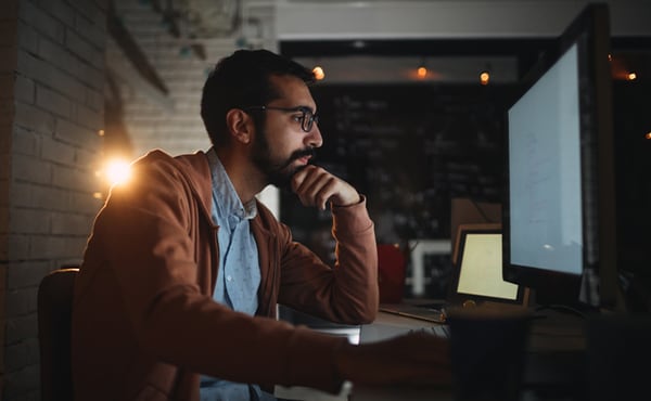 man working on computer at night