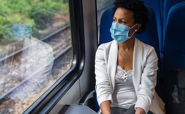masked woman on train