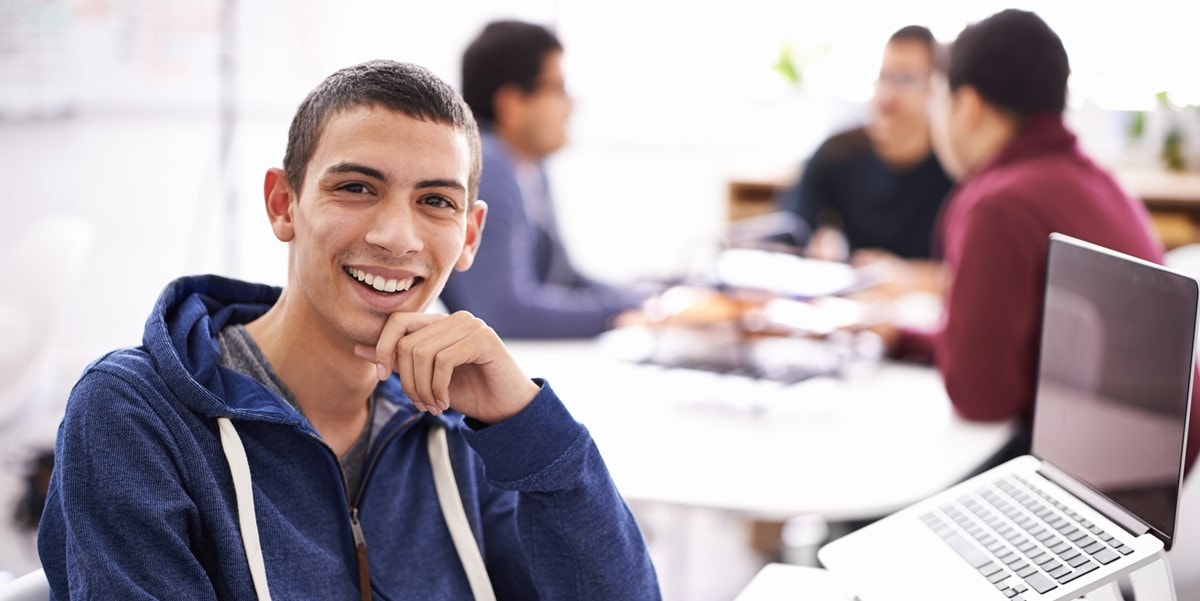 young man at desk with laptop, office