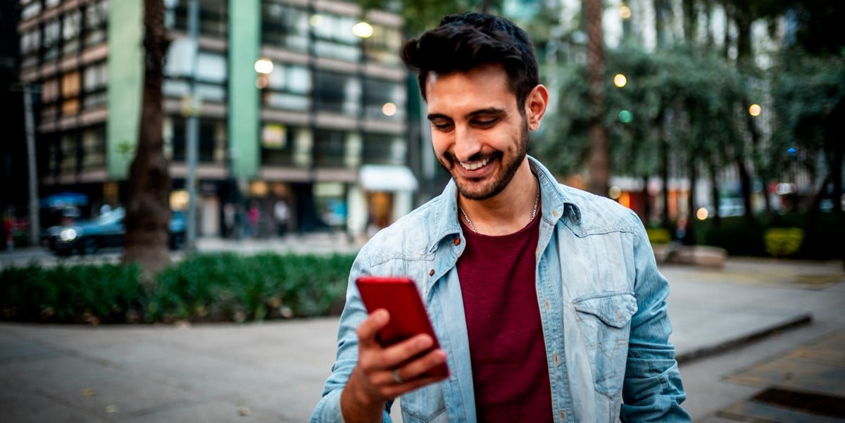 man outside with phone