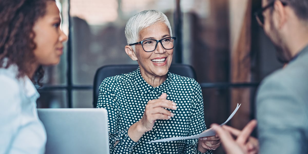 woman in meeting with 2 other people