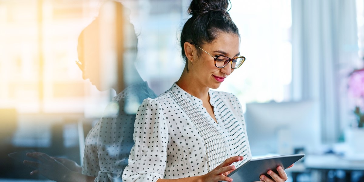 professional woman in office holding tablet