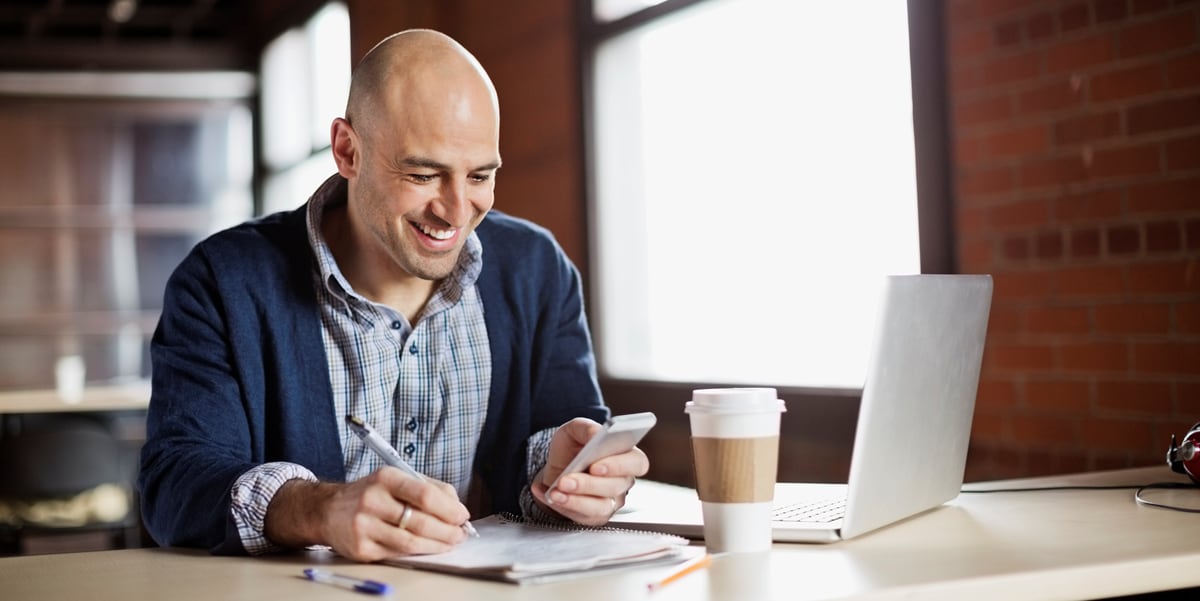 smiling man at his desk