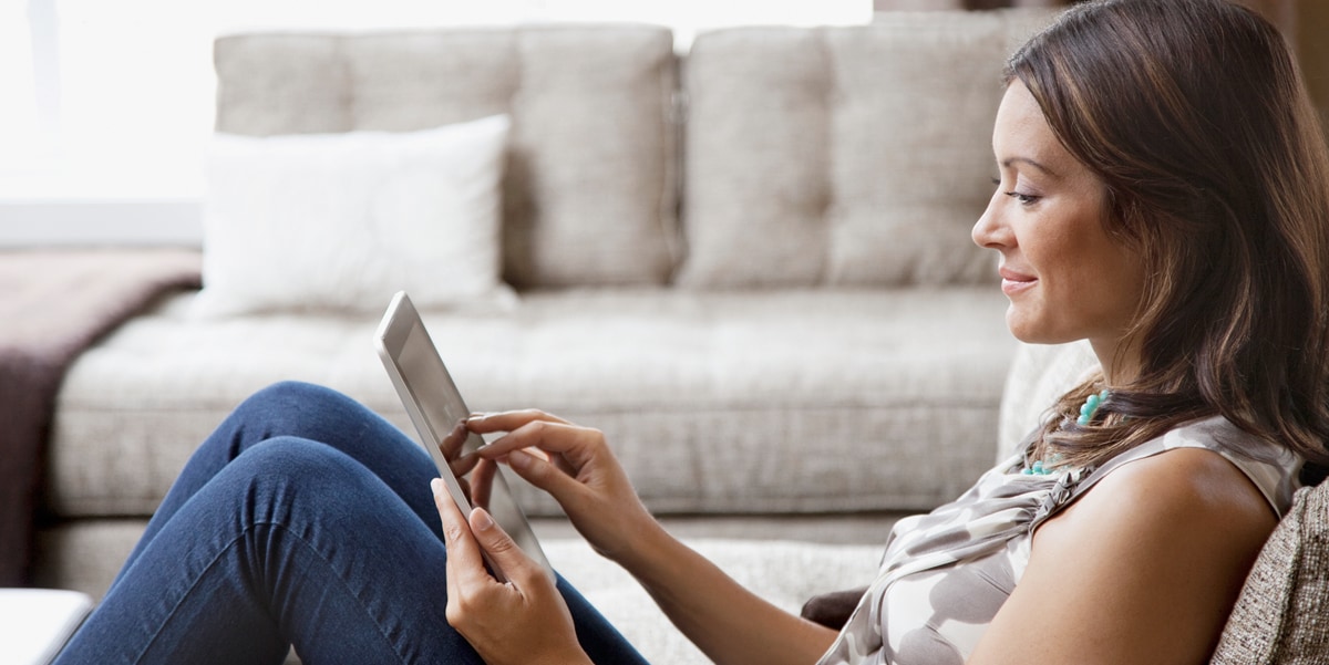 Woman sitting using a tablet