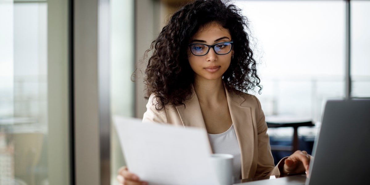 Woman working at a desk on her laptop