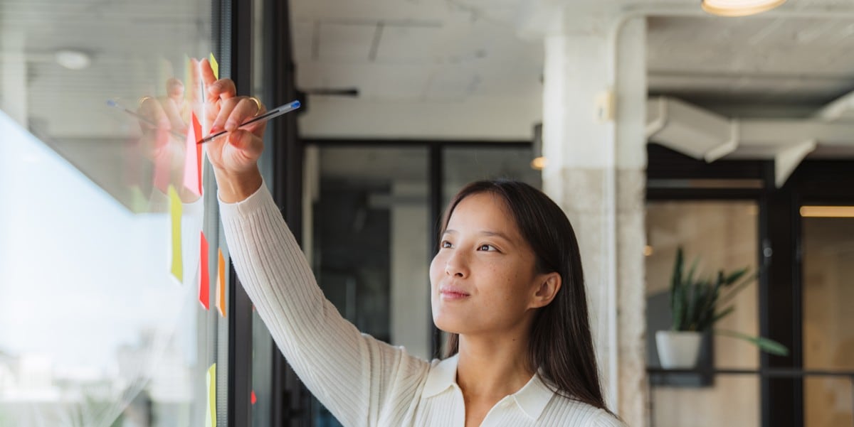 woman in the office writing on whiteboard
