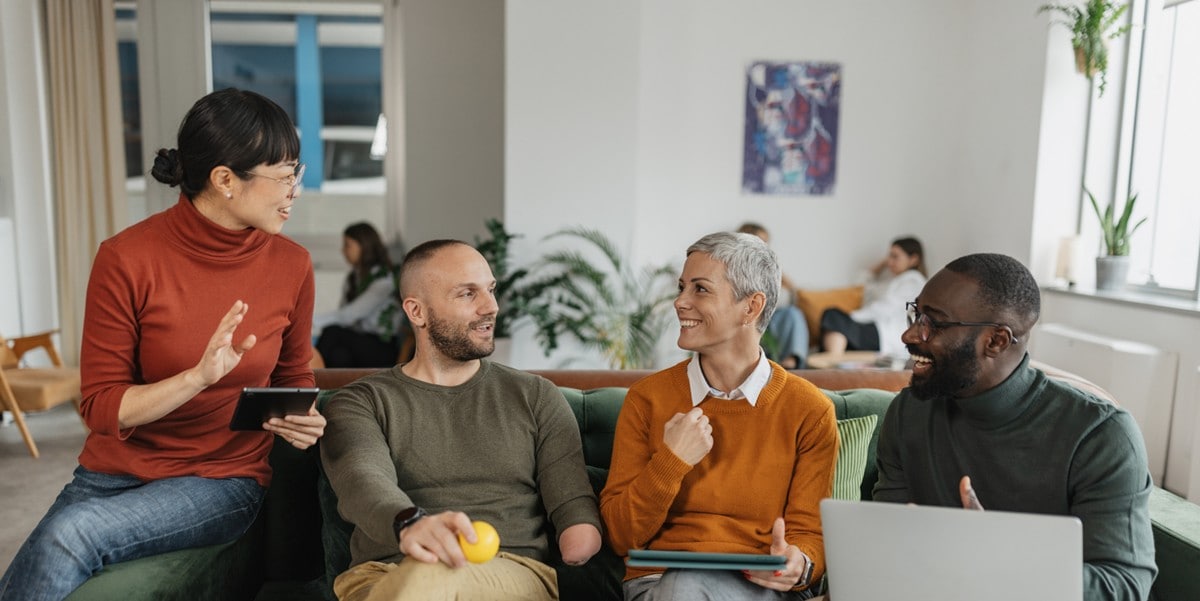 group of professionals meeting in the office, sitting on a sofa