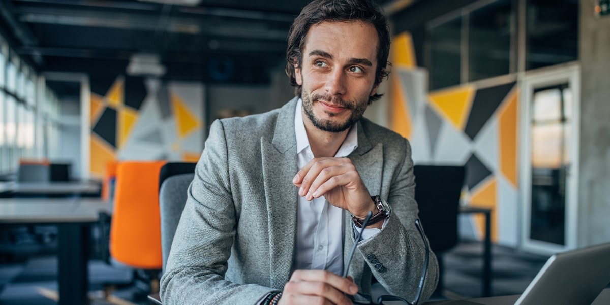 professional man smiling, in the office