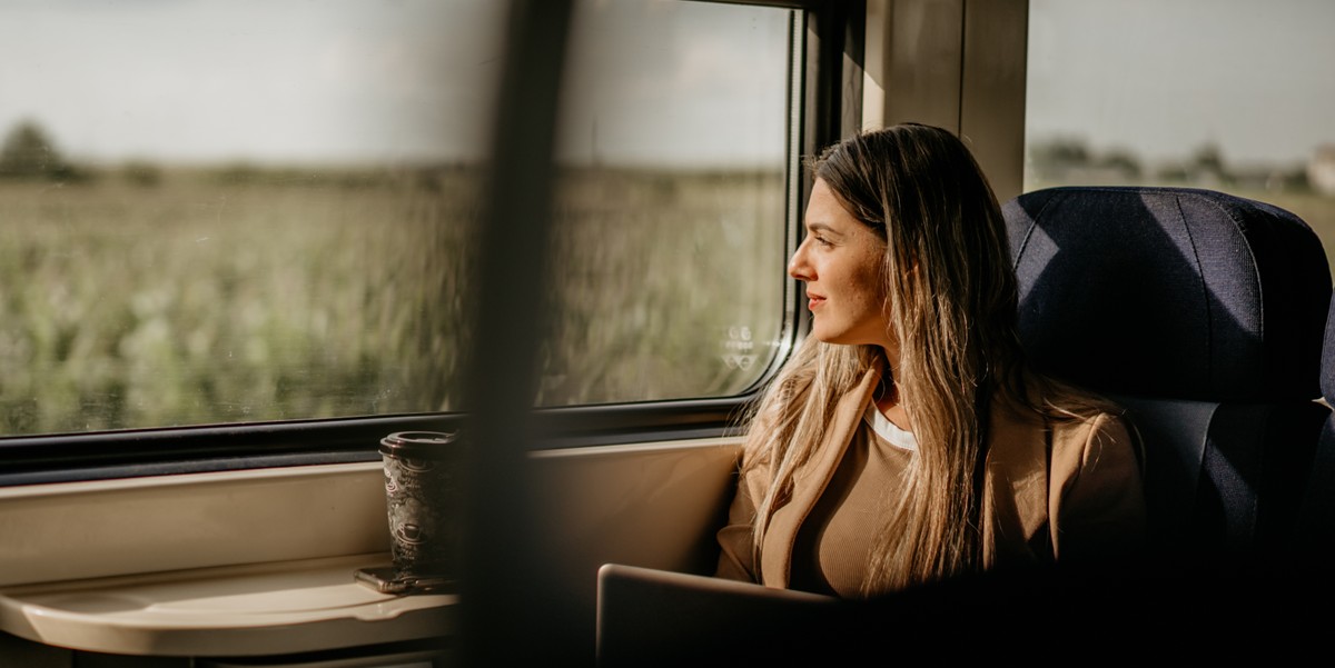 traveler looking out window, on a train 