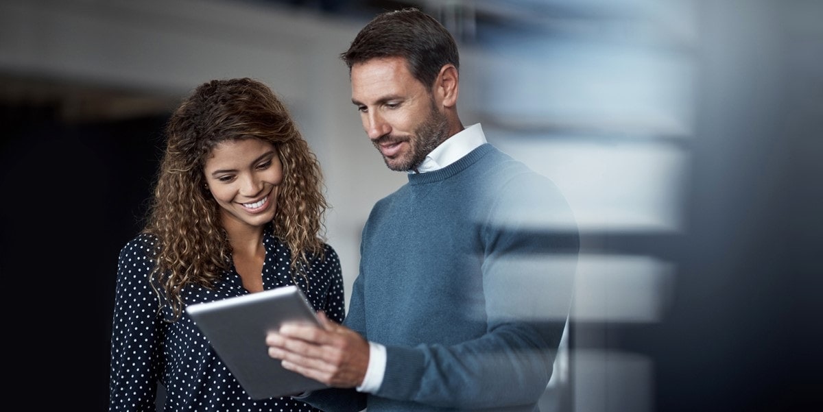 two professionals reviewing document in office