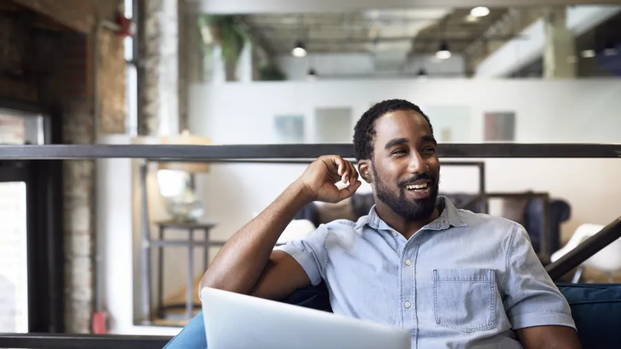 happy worker at laptop