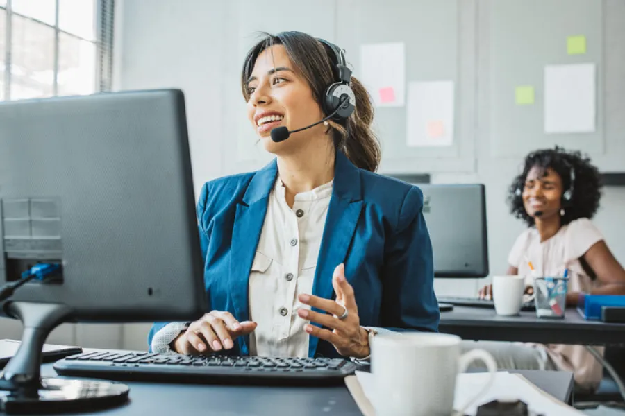 Woman on headset at computer